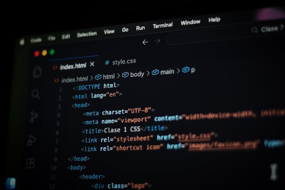 A computer screen displays a coding window with HTML and CSS code, featuring tags such as <html>, <head>, <title>, and <link>, illuminated by soft lighting. The code, written i
